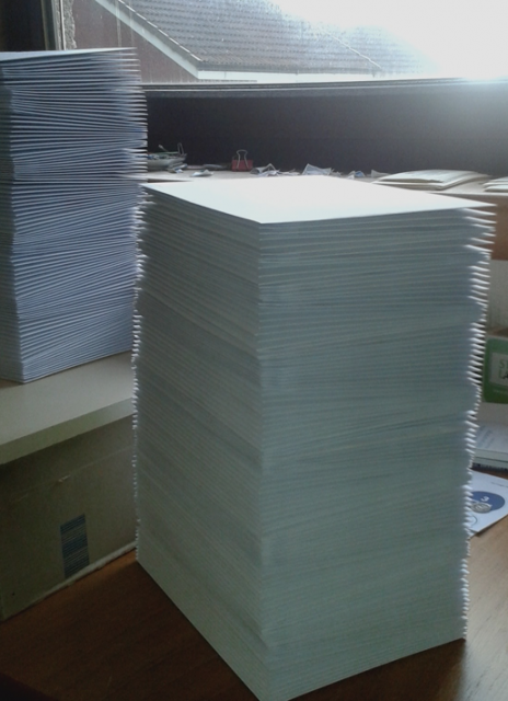 Photograph of large pile of envelopes, resembling a small skyscrap[er